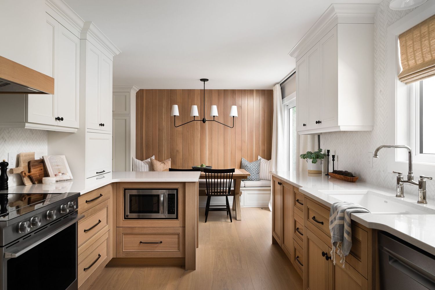 Open concept kitchen with two-tone cabinetry, white quartz countertops and pendant lighting.