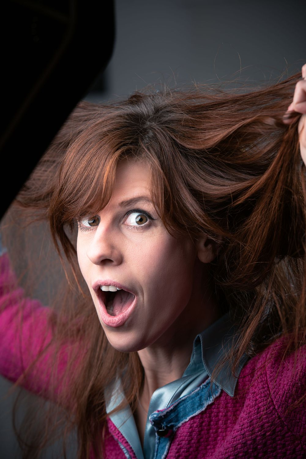 Portrait of a woman holding her hair