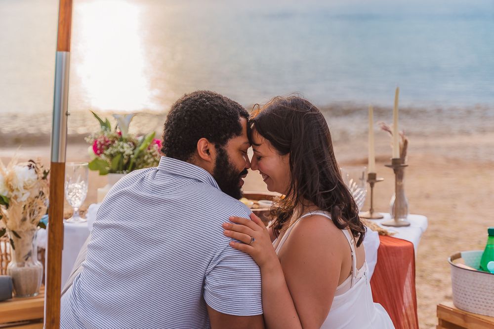 Couple touching foreheads on beach