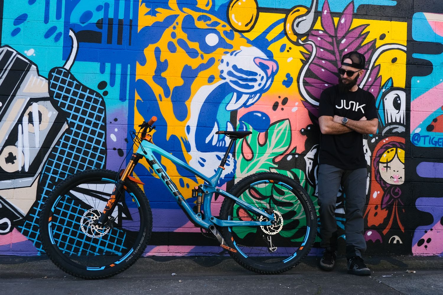 A man stands next to a Trek bicycle for a photography session by Tiffany Arnold Photography in Bentonville, Arkanas.