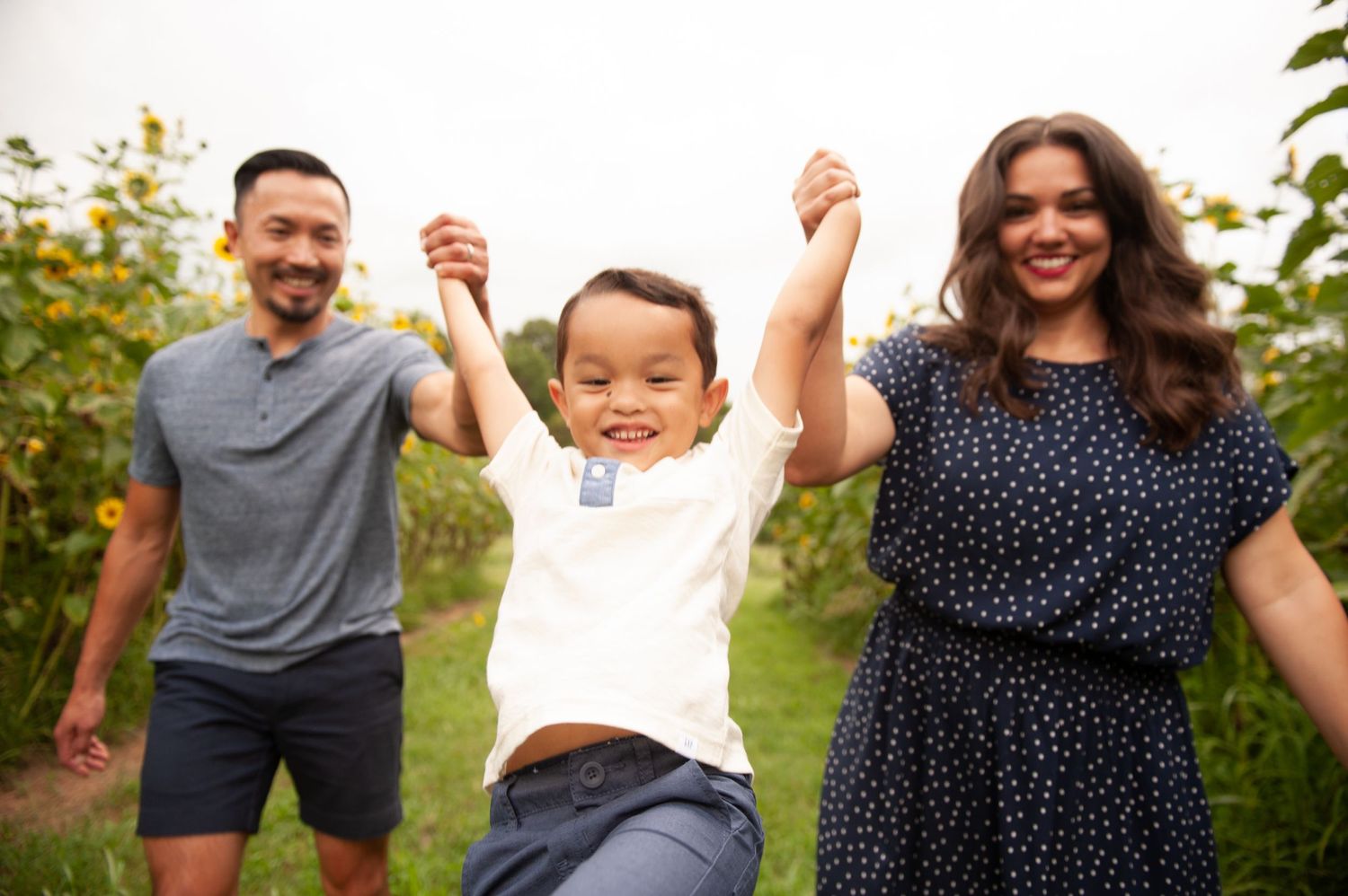 Happy family enjoying playful moments together in an outdoor setting.