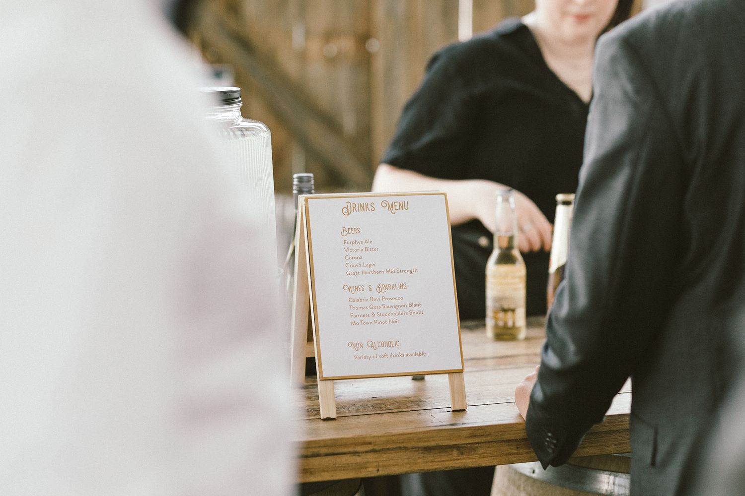Elegant cocktail bar setup with glassware at an outdoor event.