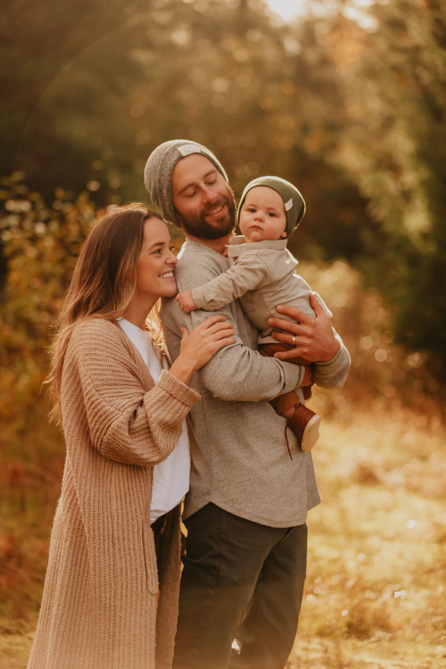 A family shares a warm autumn moment together in golden sunlight.