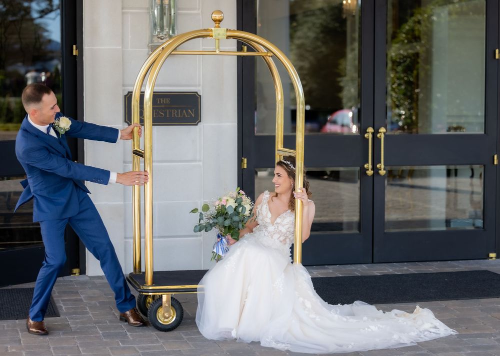 Bride and groom playing around in front of the venue in Greenville South Carolina