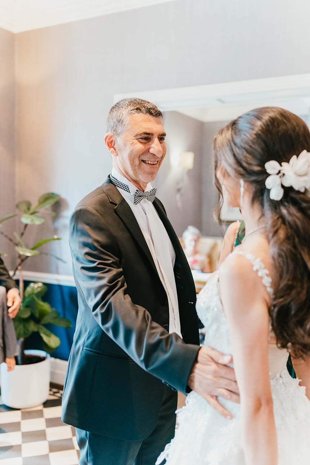 Emotional moment between bride and family member during wedding preparations.