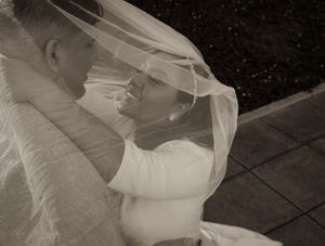 Black and white intimate wedding portrait under bridal veil.