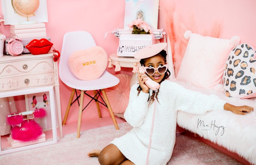 Pink themed lifestyle photography setup with modern furniture and decor.