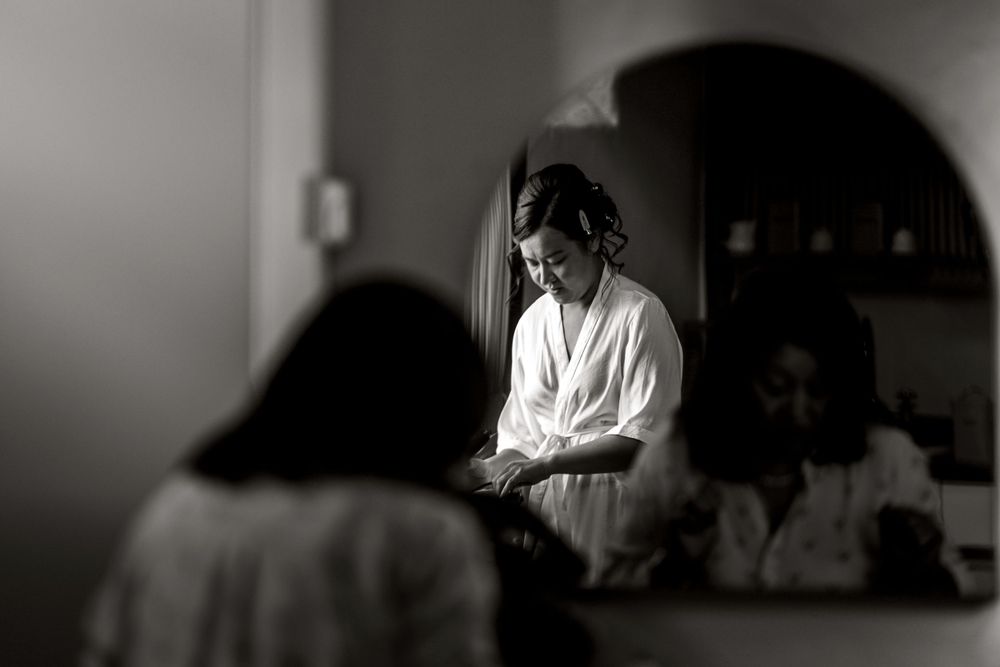 Atmospheric black and white photograph showing preparations in a dimly lit interior space at Merriscourt.