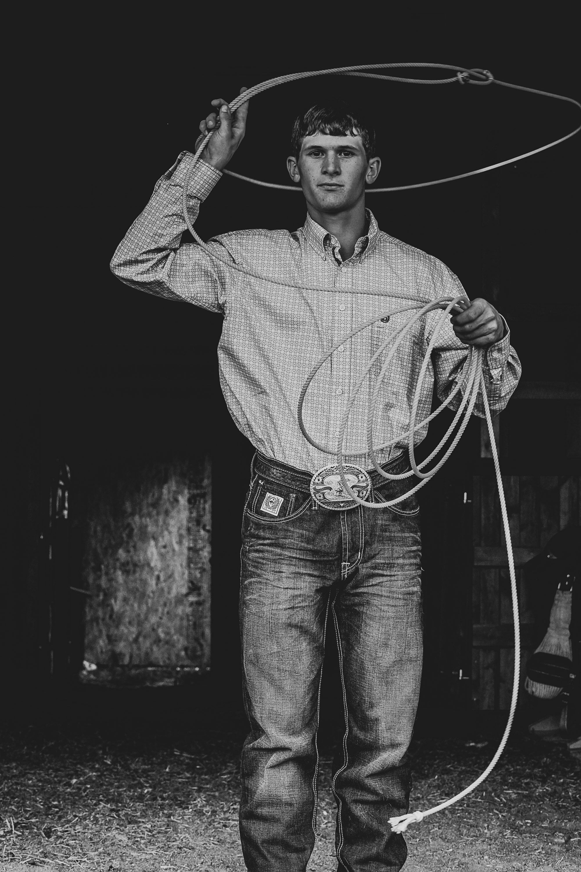 Black and white sequence showing person practicing rope tricks in dark setting.