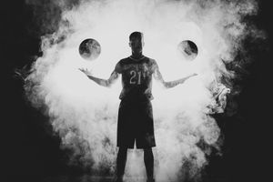 Dramatic silhouettes emerge through white smoke against a dark background in an artistic sequence.