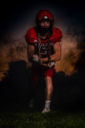 Dramatic nighttime football action shots with red uniforms against dark sky.