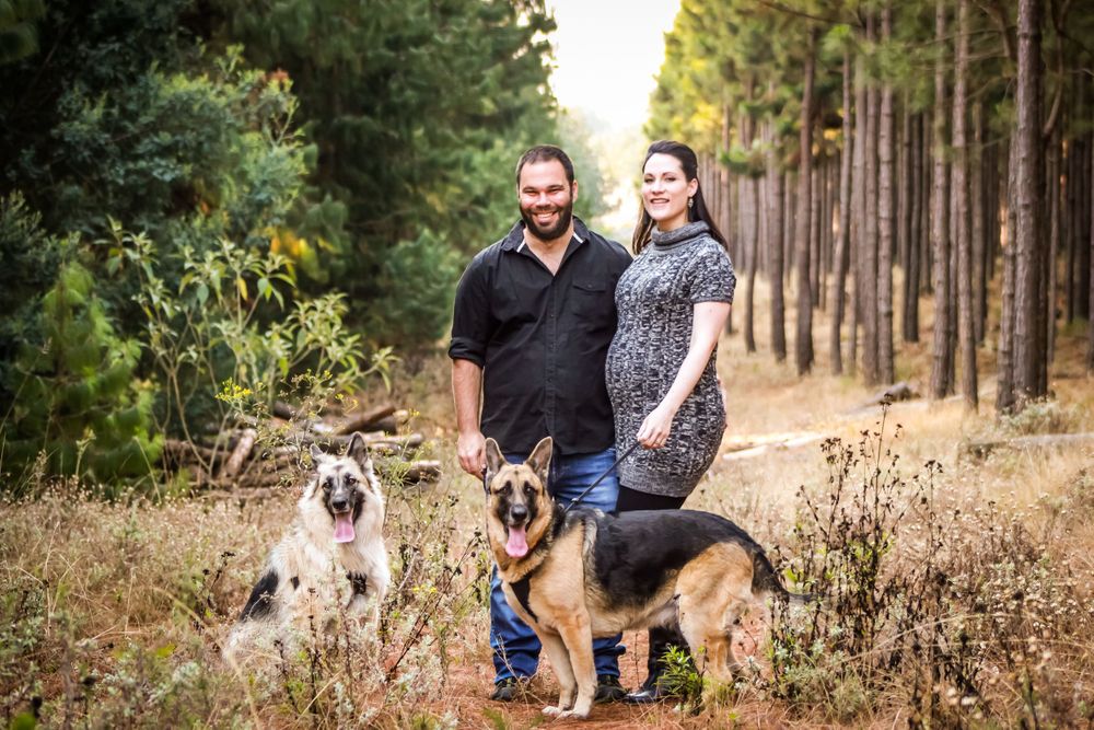 pregnant woman family man dogs leash woods forest trees background photo shoot photography maternity clothes love happy