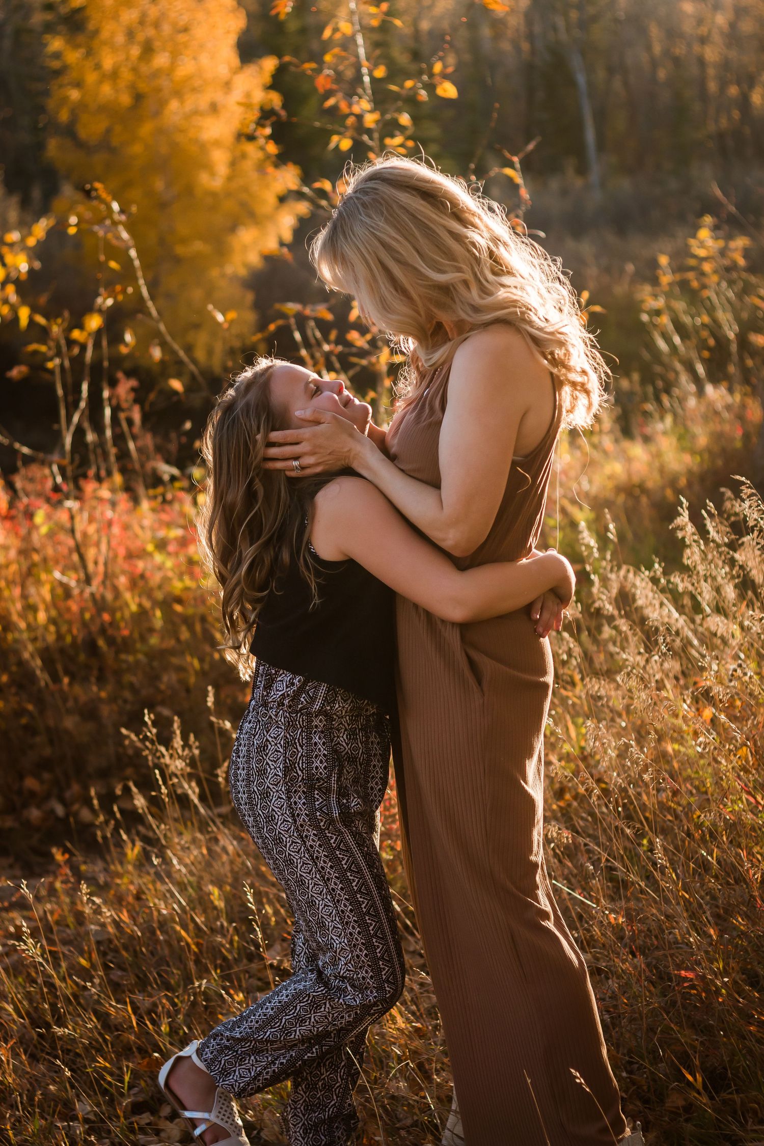 Beautiful authentic motherhood moment during fall lifestyle family photos in Calgary AB by Love & Sunshine Photography.