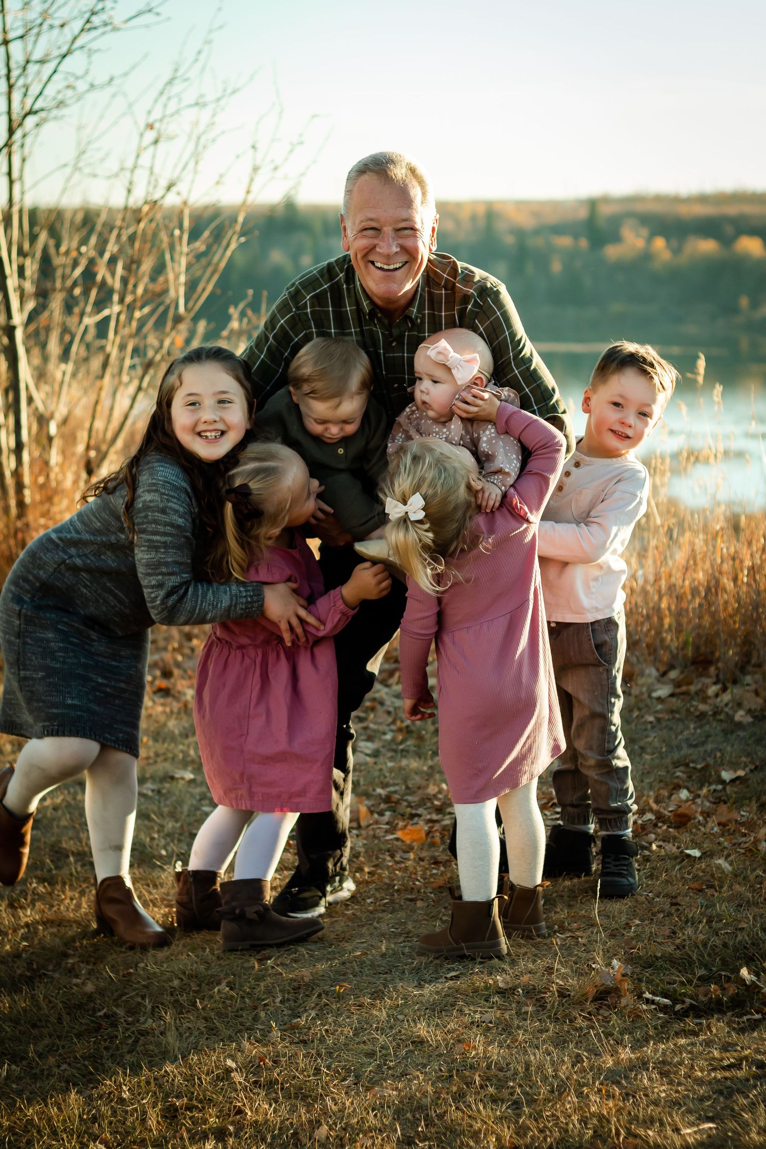 Beautiful extended family photos at golden hour at Glenmore Reservoir in Calgary AB.