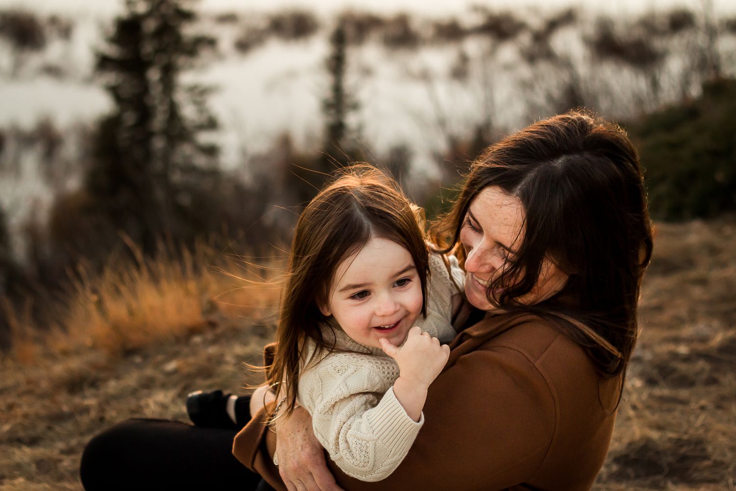 Beautiful mother & daughter moment in Calgary AB during golden hour fall family photos by Love & Sunshine Photography.