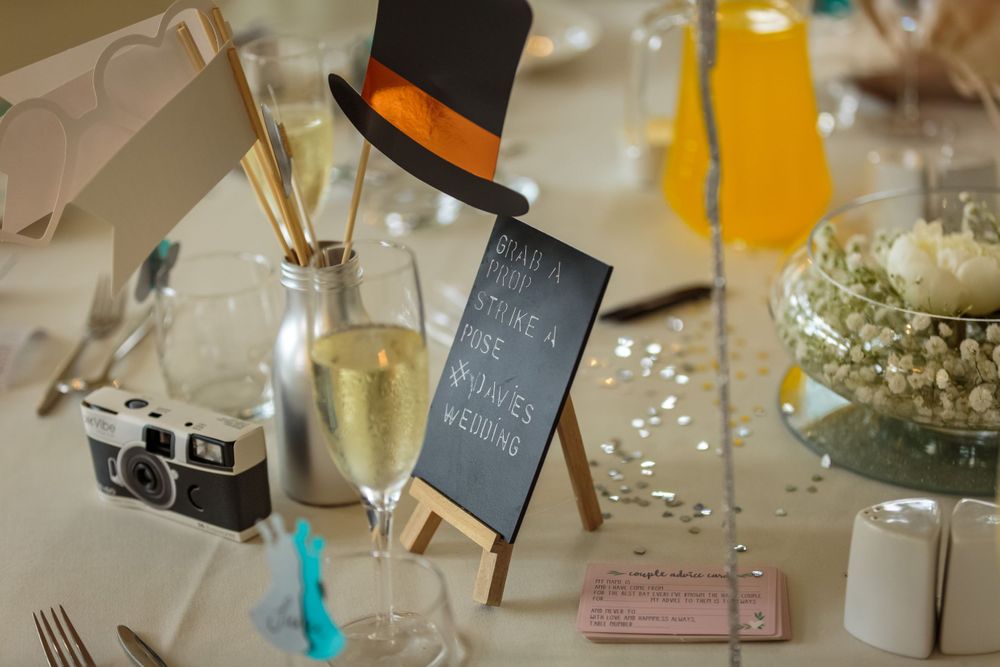 disposable camera and photo booth props on the tables at west tower