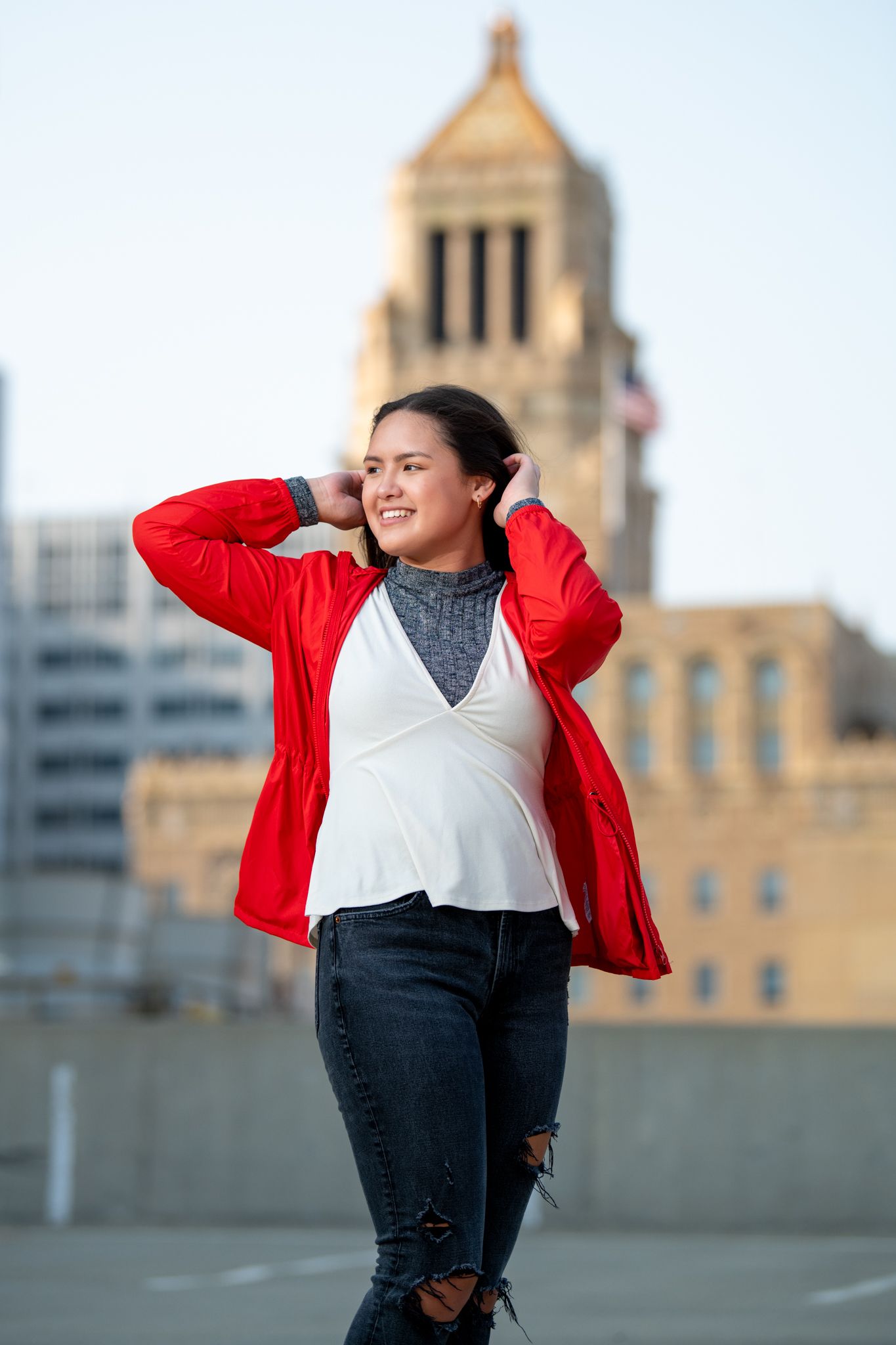 A casual urban fashion scene with historic architecture in the background.
