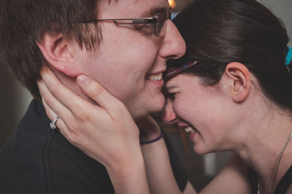 A tender moment between a couple with gentle hands on faces.