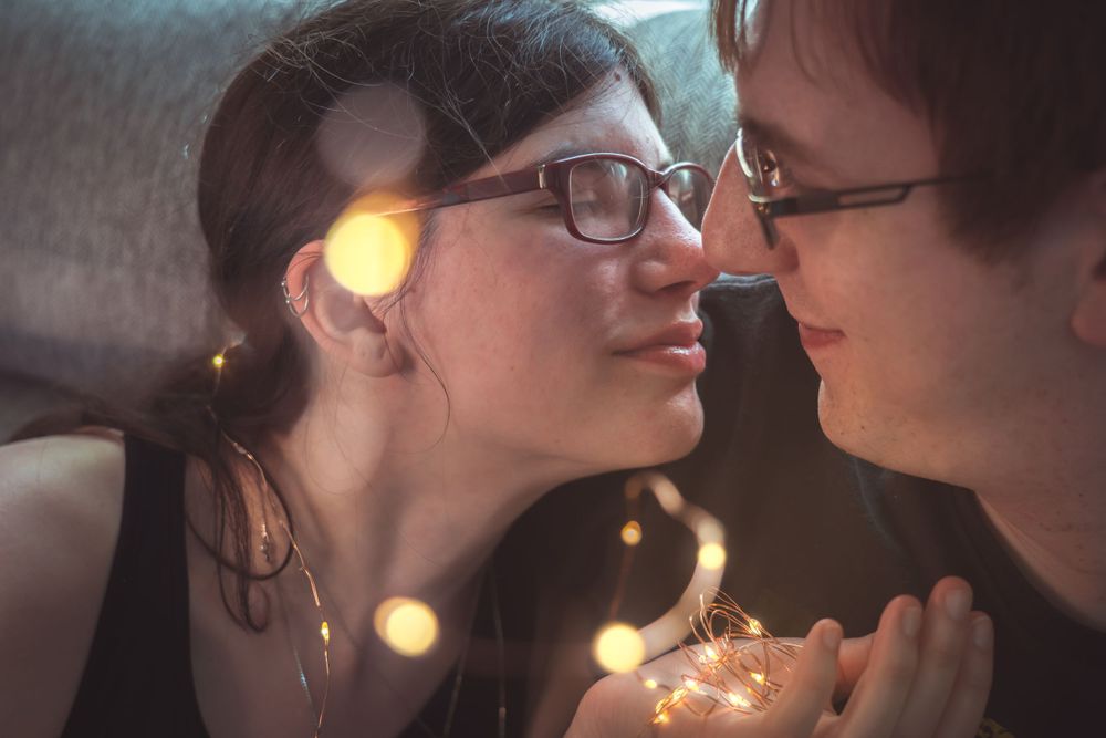 An intimate moment captured with soft bokeh lighting effects.