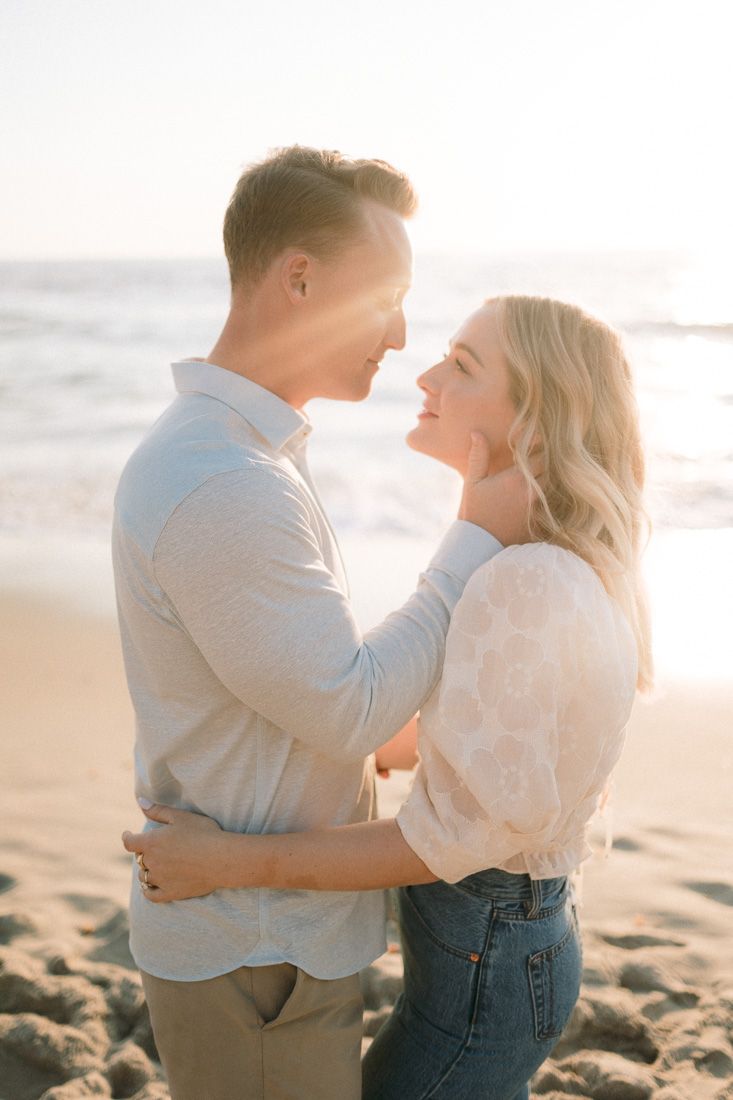 Happy couple embracing on beach at sunset.