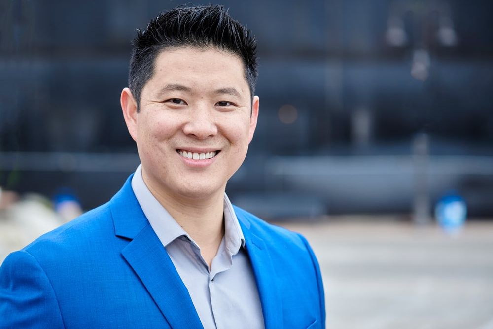 headshot of male real estate agent in gorgeous blue suit outside building at Point Ruston, Tacoma