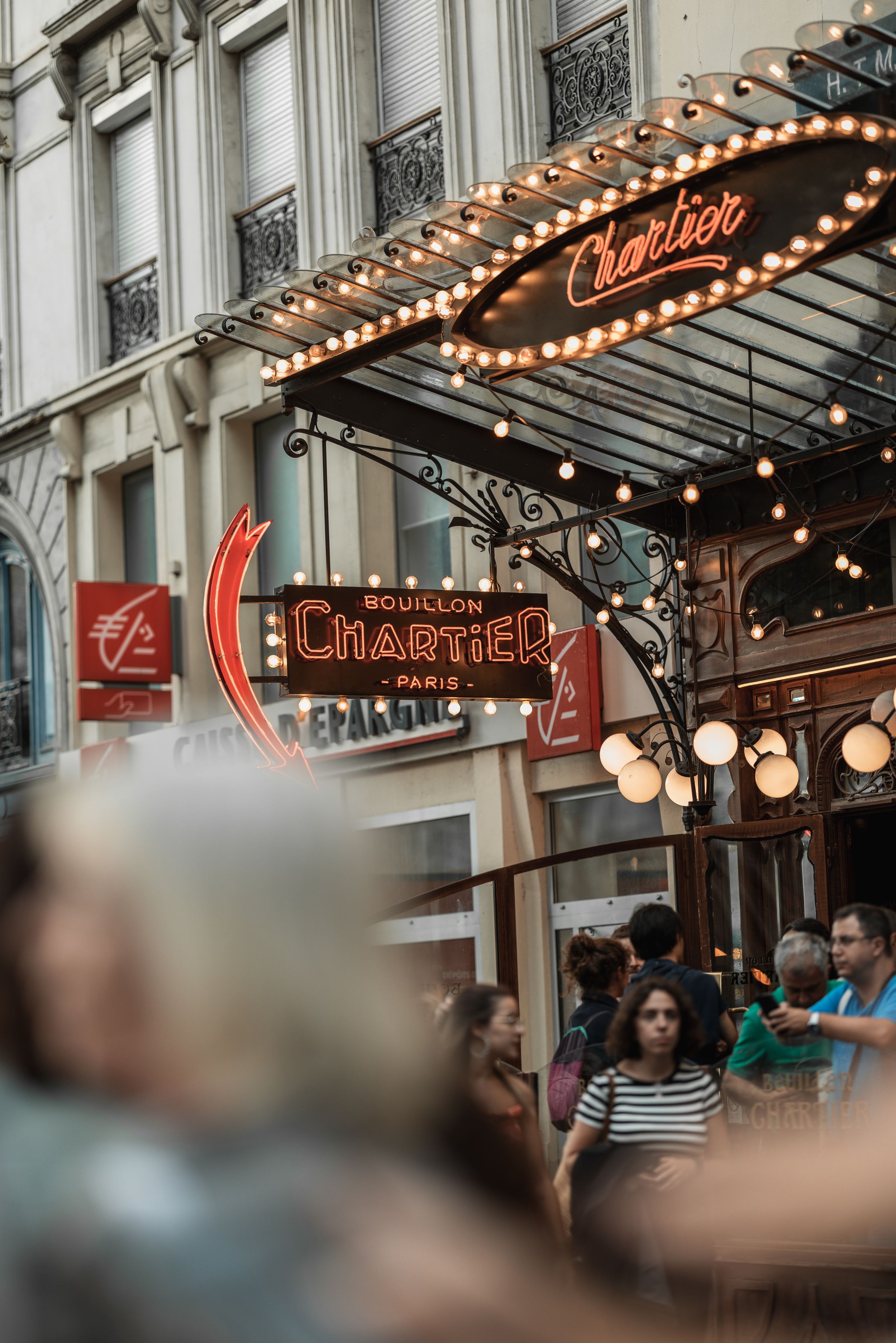 Vintage illuminated theater marquee with string lights in Paris.