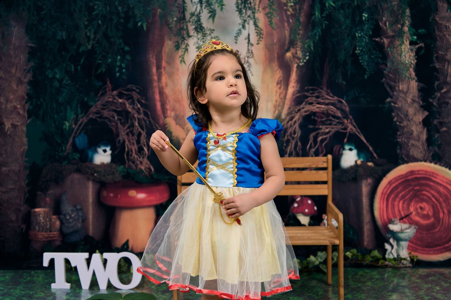 Fantasy themed photoshoot in enchanted forest setting with vintage props.