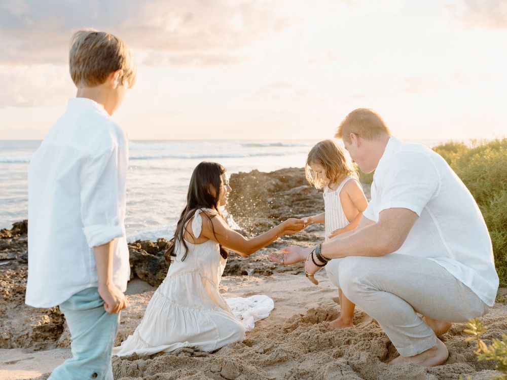 A family photoshoot by Moments With Kell on Oahu in Hawaii on the sand