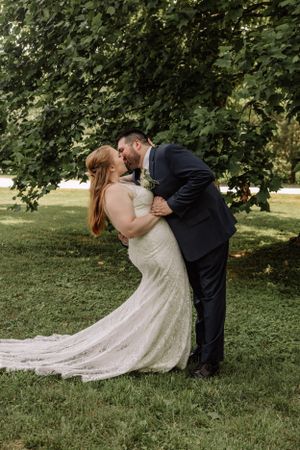 Elegant wedding photography sequence showing romantic dip kiss pose under leafy green trees.