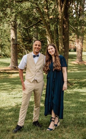 Casual wedding party portraits in outdoor setting with guests in navy and beige attire.