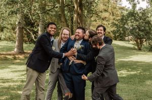 Candid moments of wedding party members laughing and playing in a park setting.