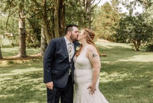 A couple shares a happy moment during their outdoor wedding celebration.
