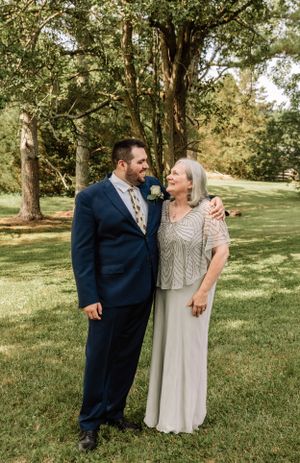 Couple shares intimate moment during outdoor wedding photo session in park setting.