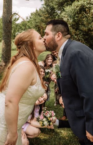 A romantic wedding kiss moment captured in a series of candid photos outdoors with bridesmaids looking on.