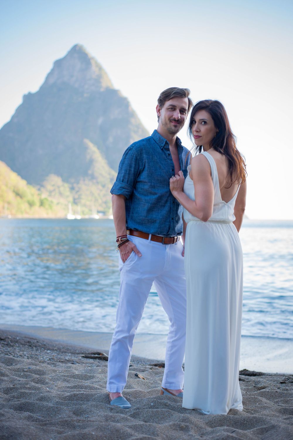 Romantic beach photoshoot with couple against Saint Lucia's iconic Pitons mountains.