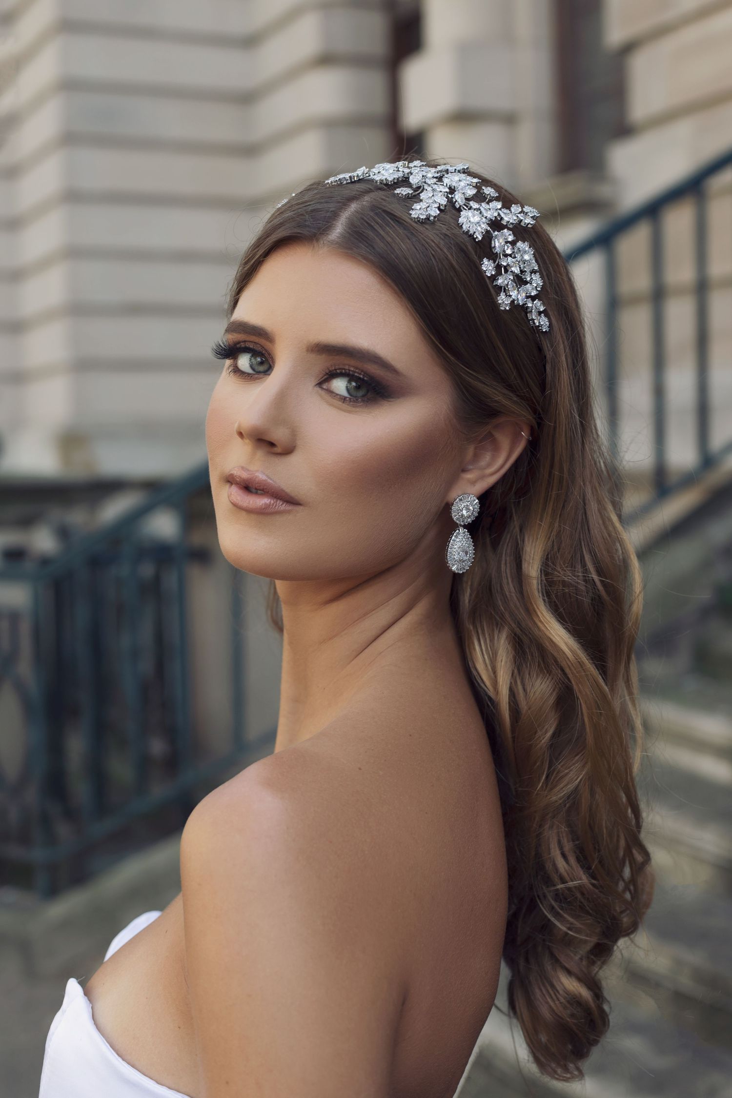 Elegant bridal portrait featuring crystal hair accessories and glamorous evening makeup.