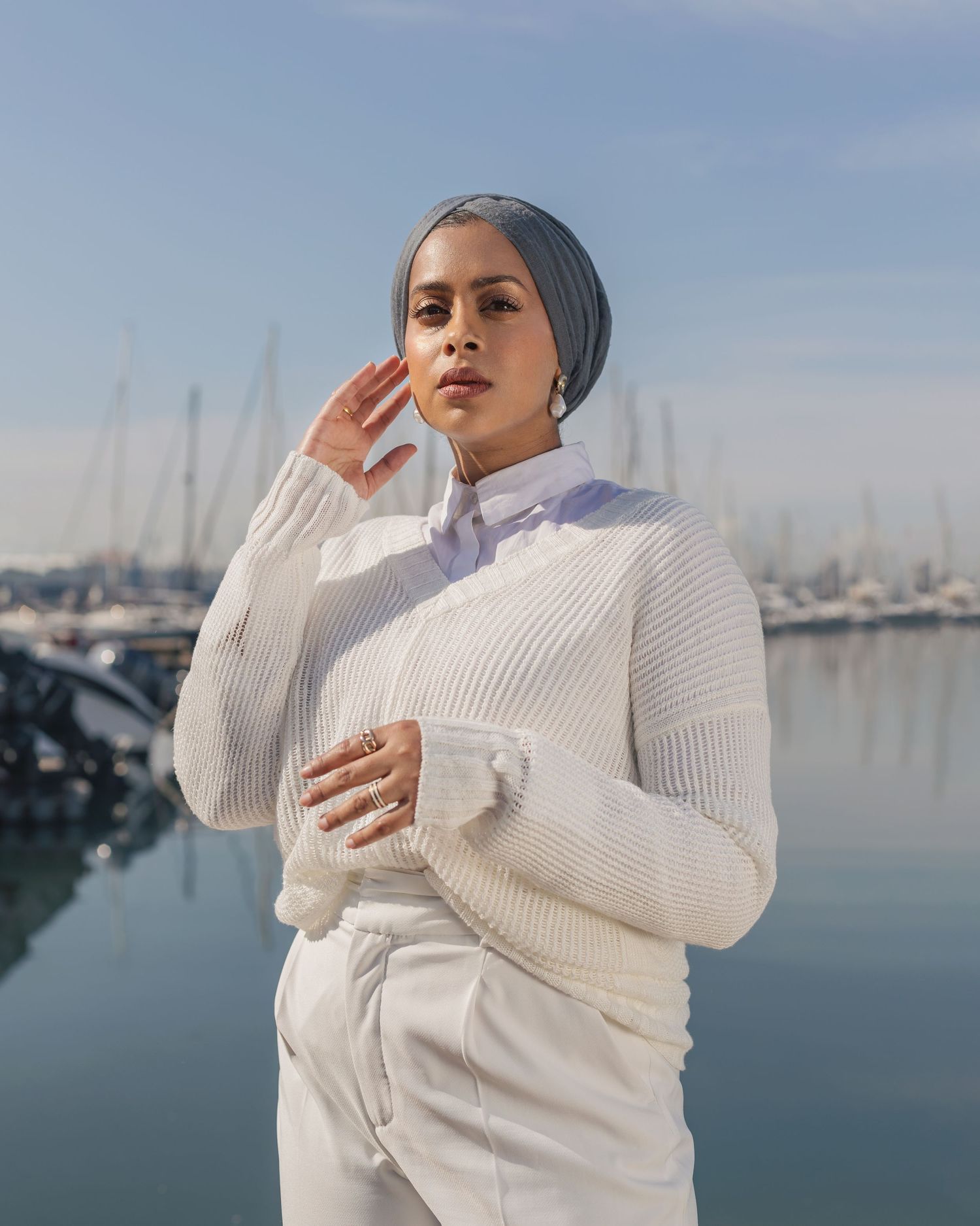 Winter fashion shot by marina featuring white knit sweater and turban style headwrap.