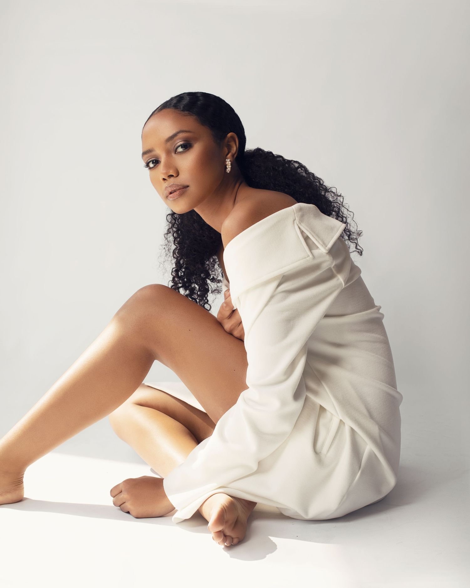<img src="studio photoshoot" alt="models sitting in a white coat">