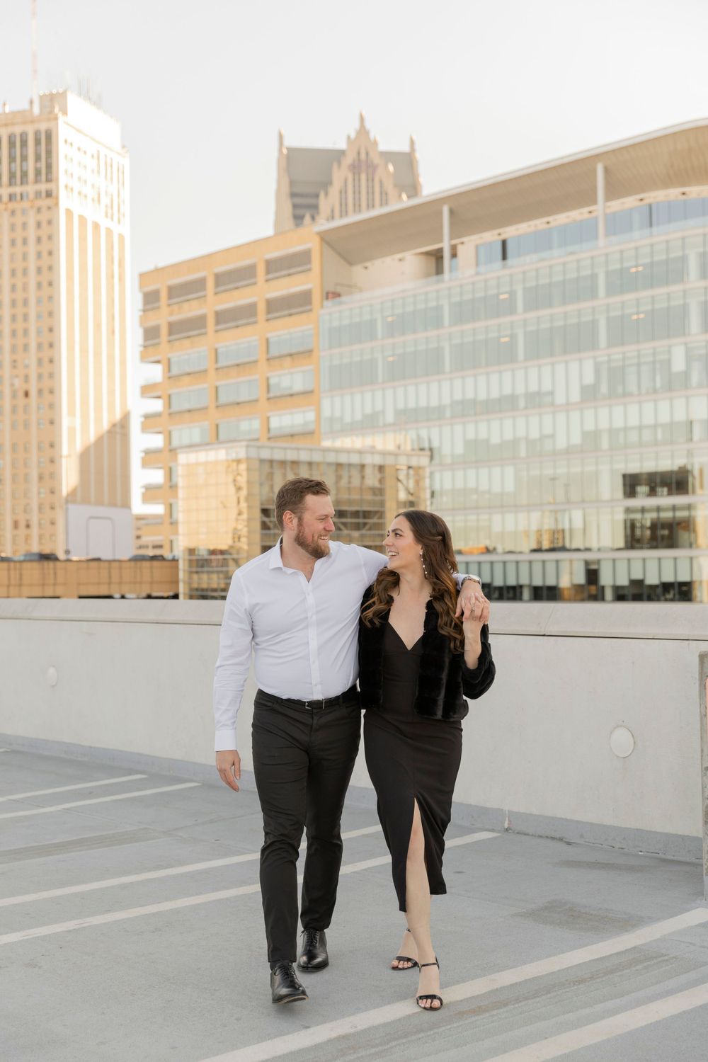 couples walking together and smiling on a parking garage rooftop in downtown detroit