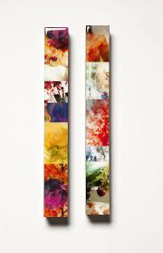 Two colorful abstract art panels featuring vibrant splashes of red, yellow and blue paint against a white background.