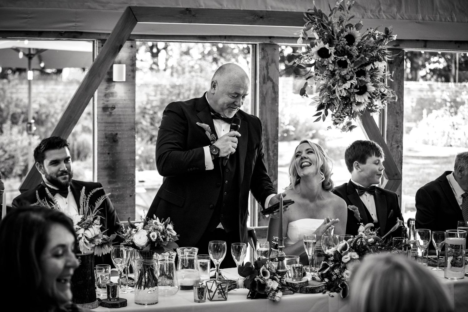Black and white candid shots of guests mingling at an outdoor wedding reception.
