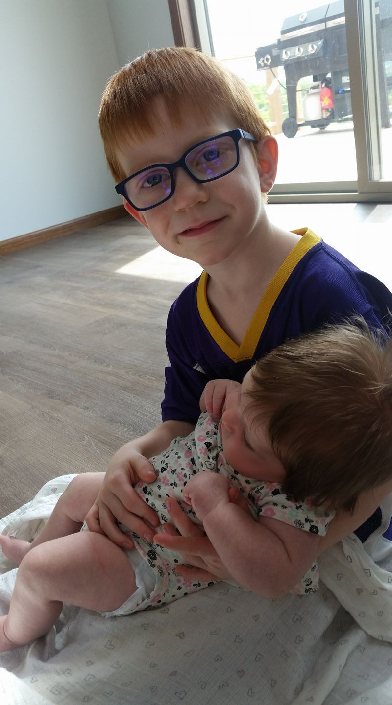 Michelle's second son holding his little sister.