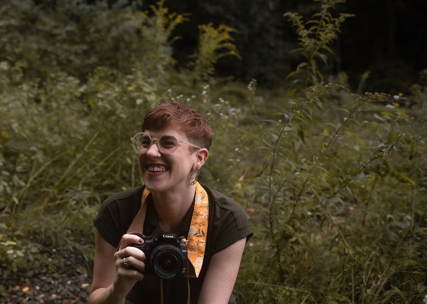 A candid image of a photographer outdoor with a camera in a natural setting at sunset in Providence, Rhode Island, RI, USA, United States.