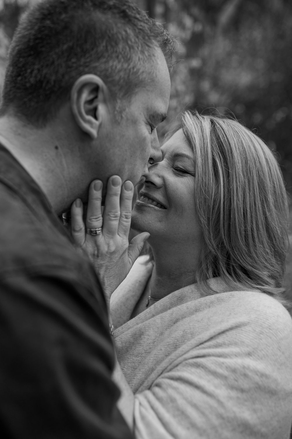 Black and white intimate portrait of couple sharing emotional moment together.
