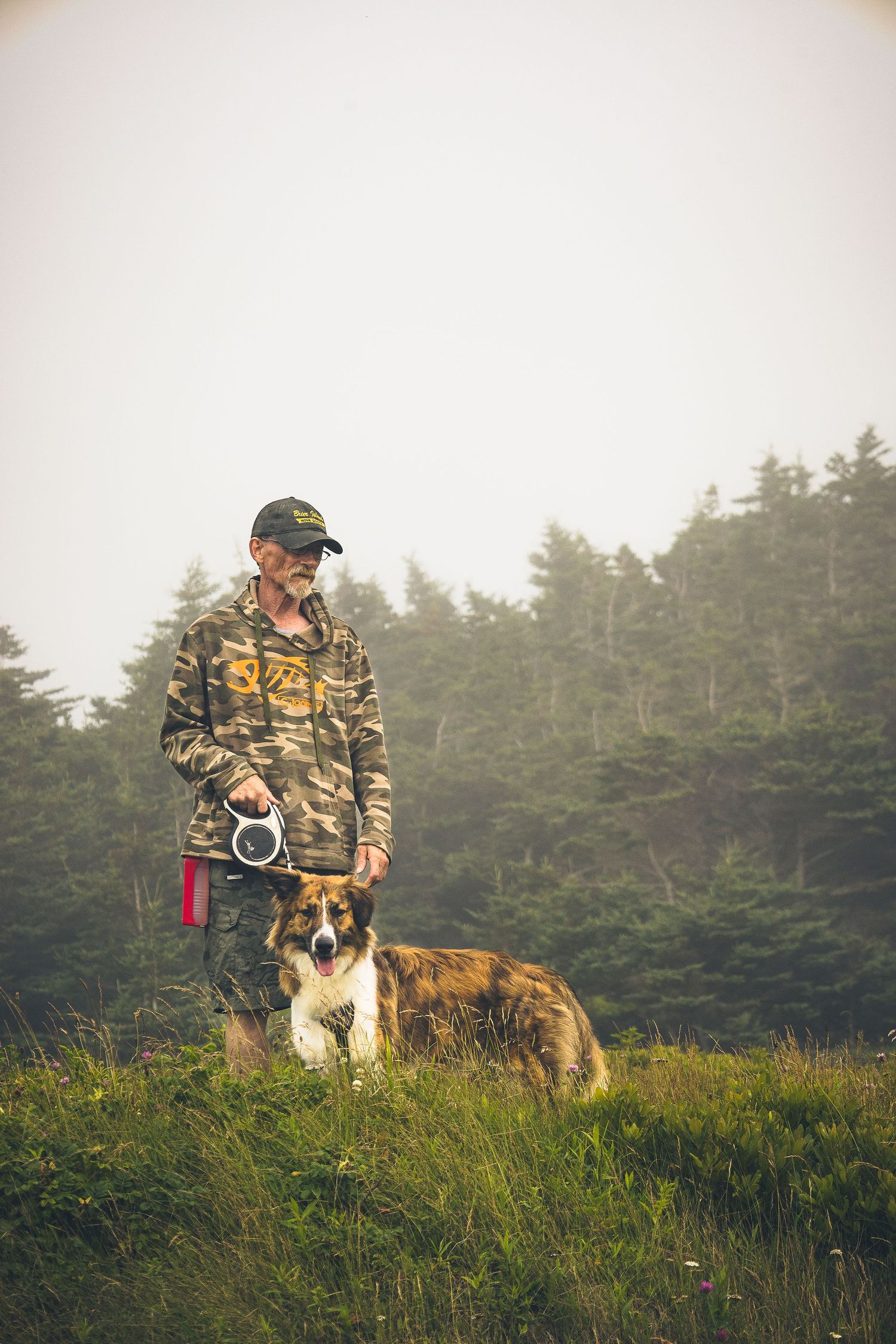 A man and his dog near the forest