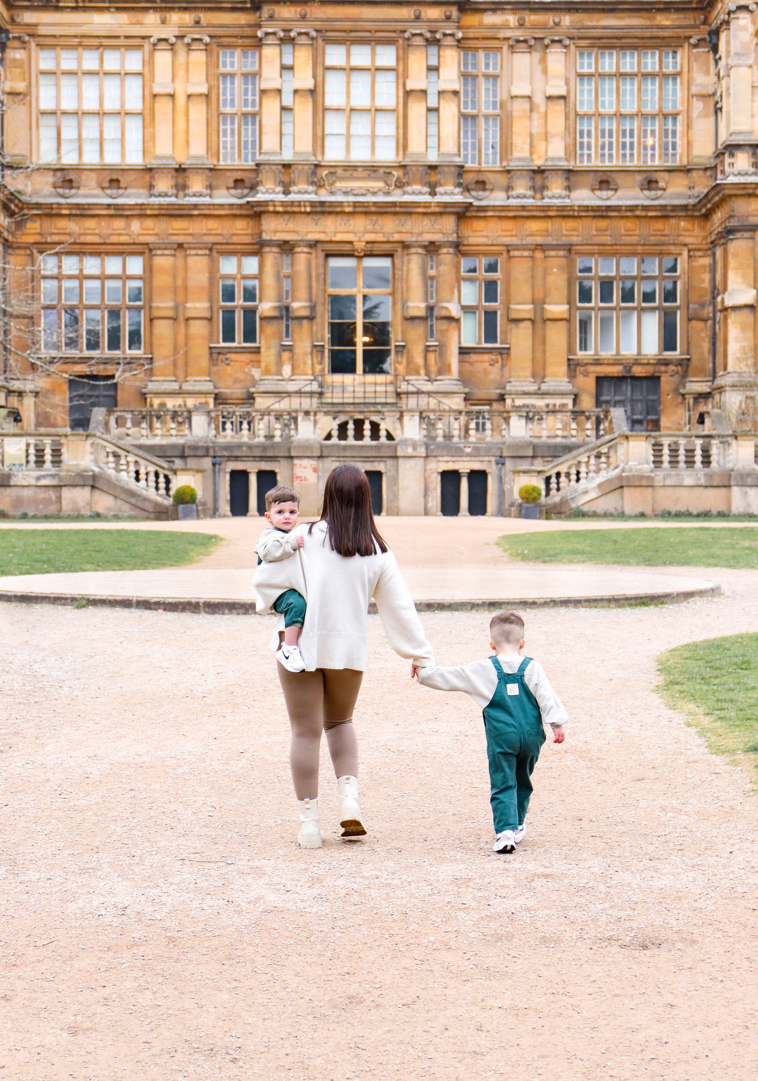 A walk together on the grounds of a majestic stone mansion.