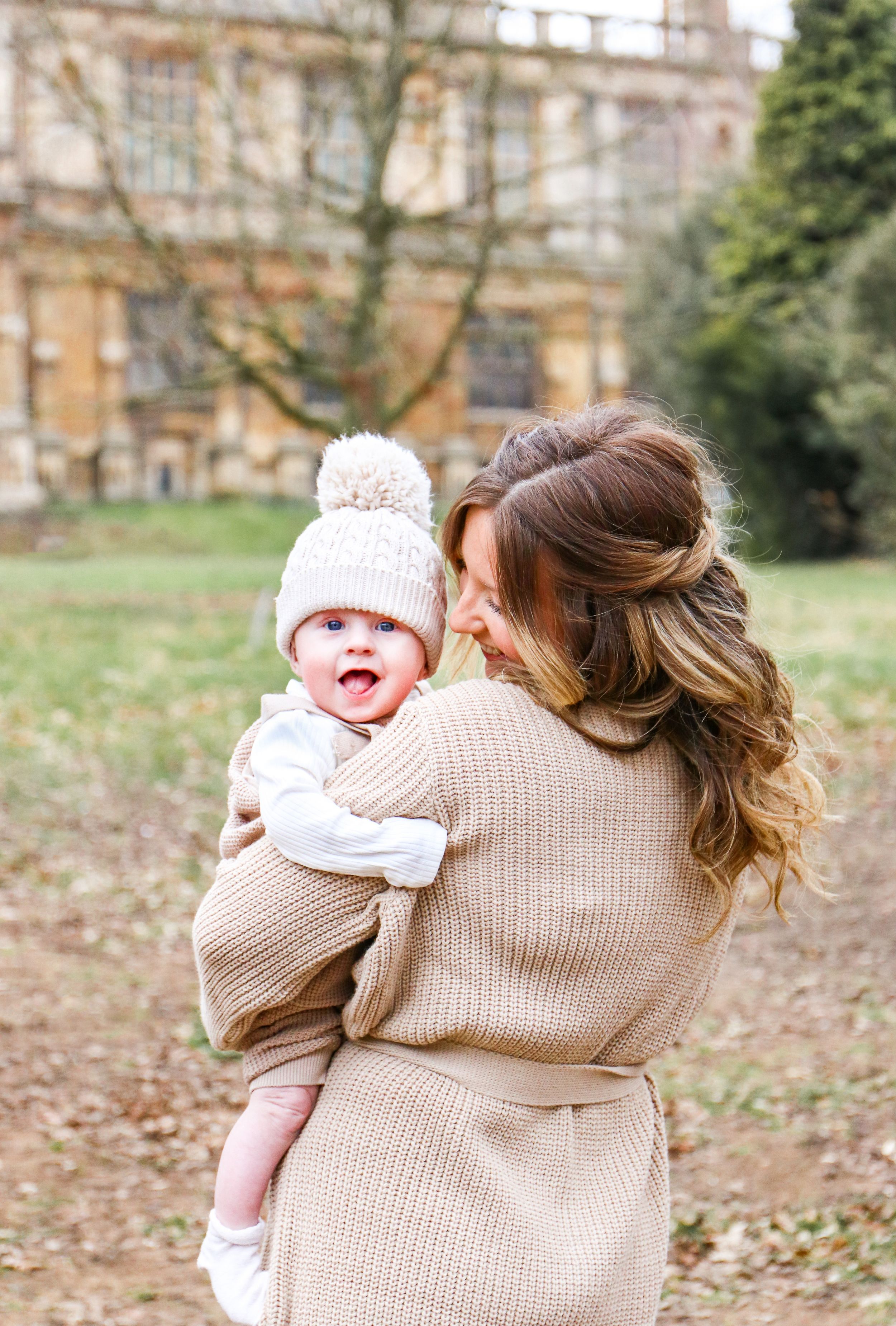 A heartwarming moment captured outside a historic stone building on an autumn day.