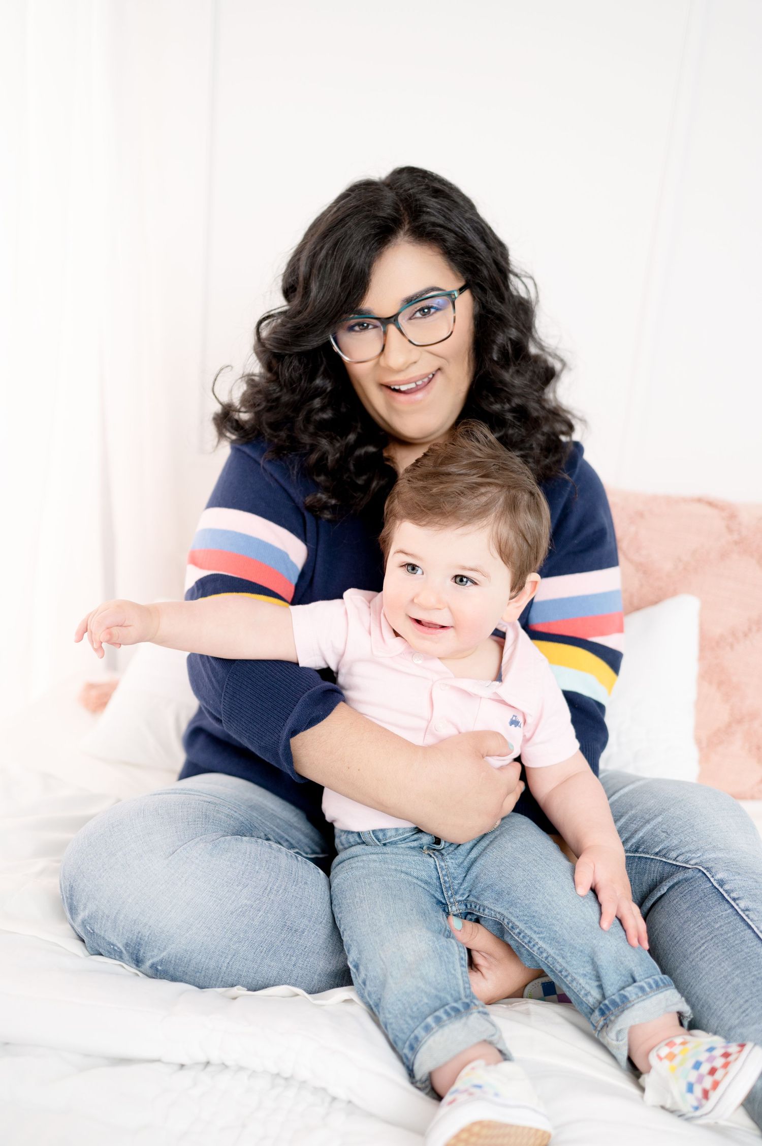 Family portrait on white couch showing tender moments and casual style.