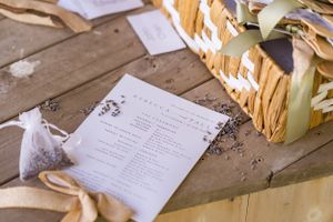 Wedding program or menu laying on wooden surface next to decorative elements in the Hudson Valley,NY.