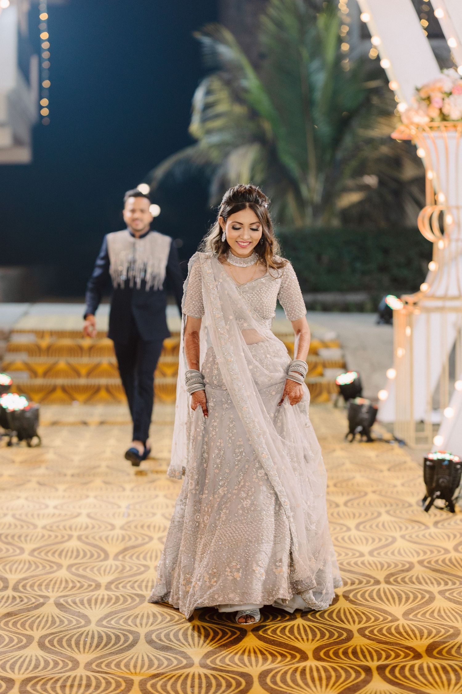Wedding reception featuring intricate patterned flooring and elegant white decor.
